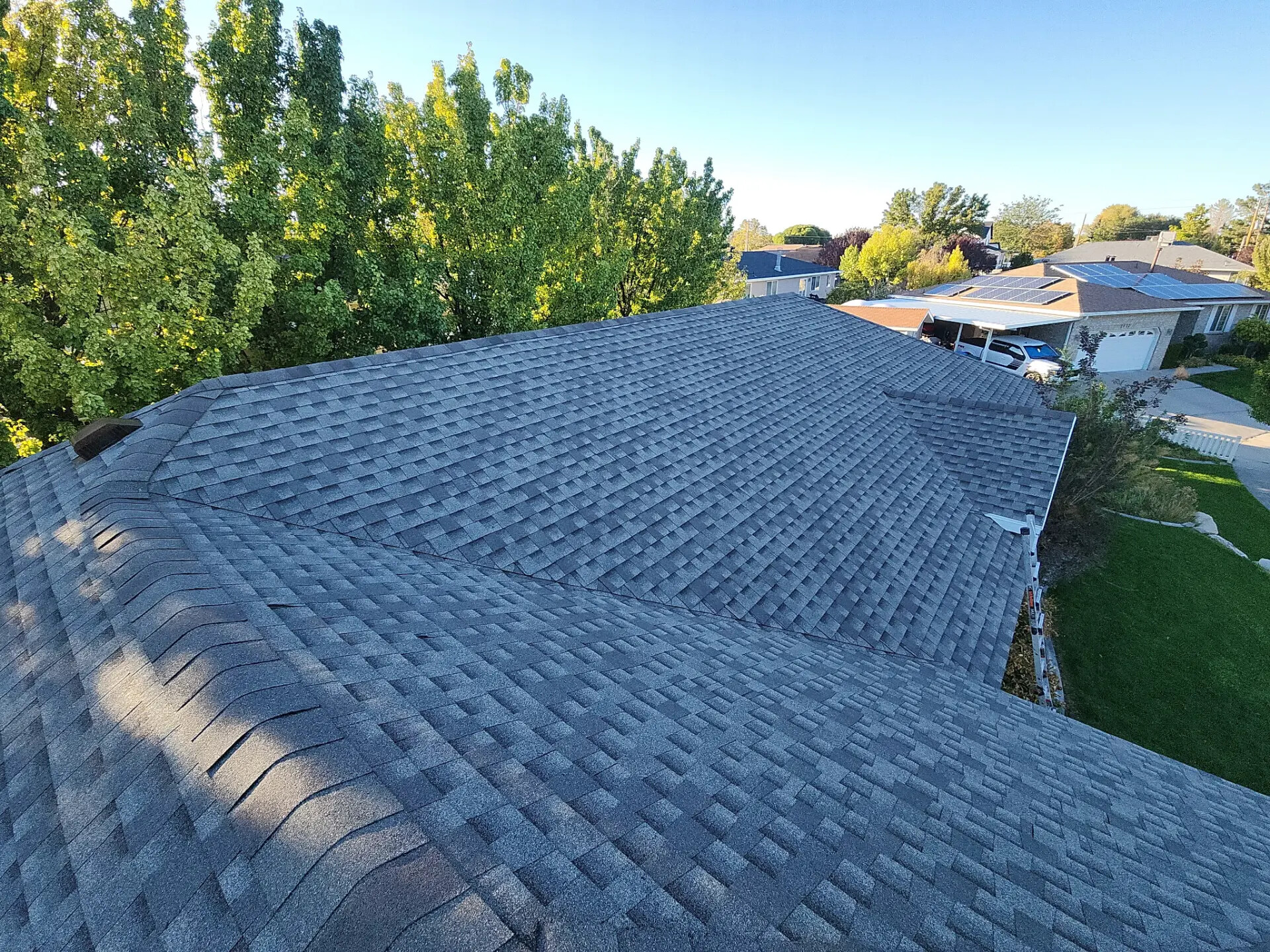 Utah home exterior in bright daylight with a well-maintained shingle roofline