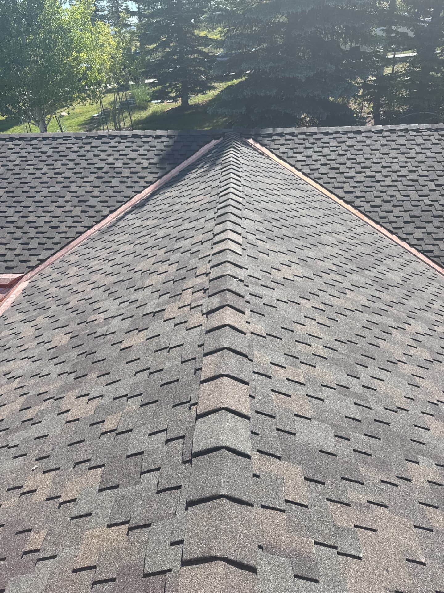 Architectural asphalt shingle roof with ridge cap detail