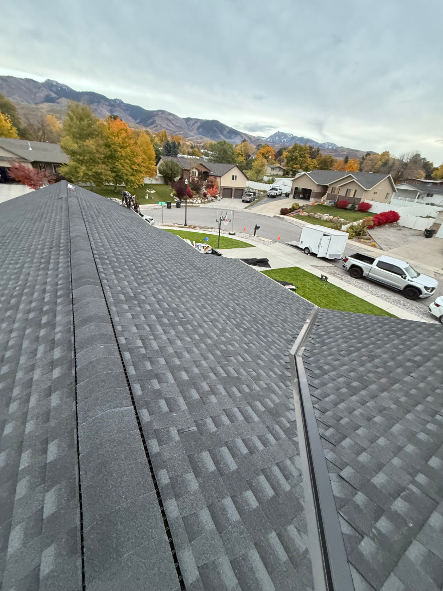 Roof surface overlooking a Utah neighborhood with mountains beyond