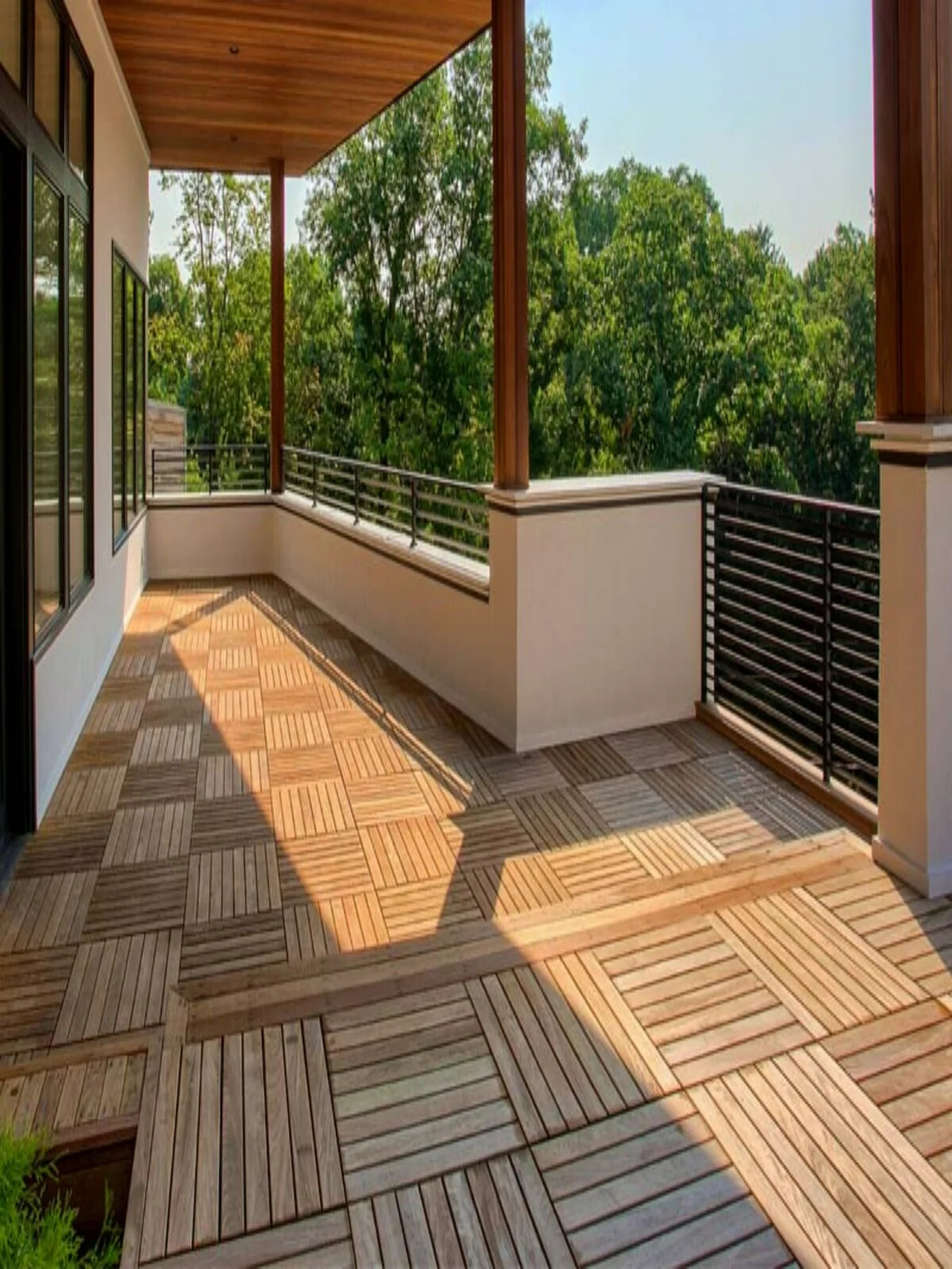Finished outdoor balcony with wooden deck tiles and modern railings