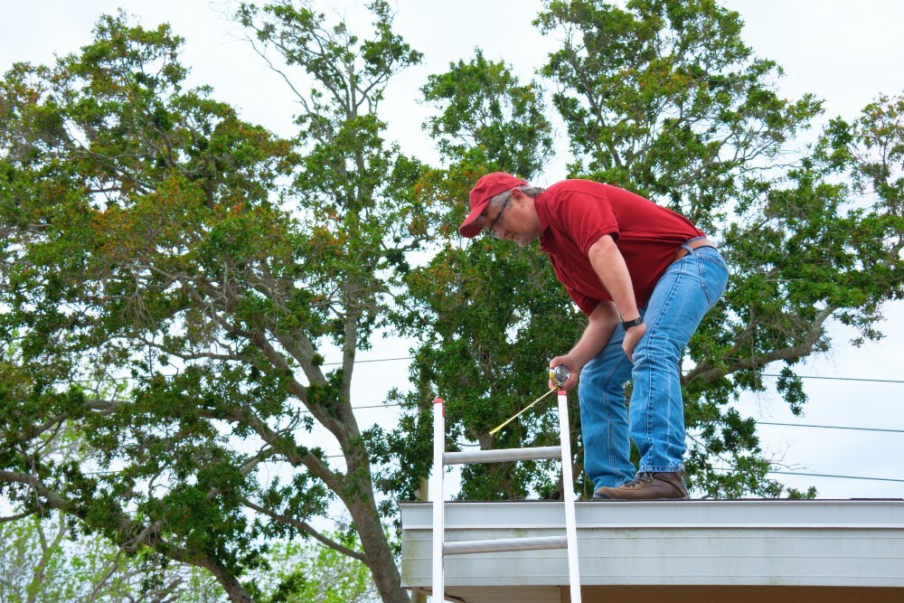 Roofing inspector examining a residential roof from the ground with binoculars