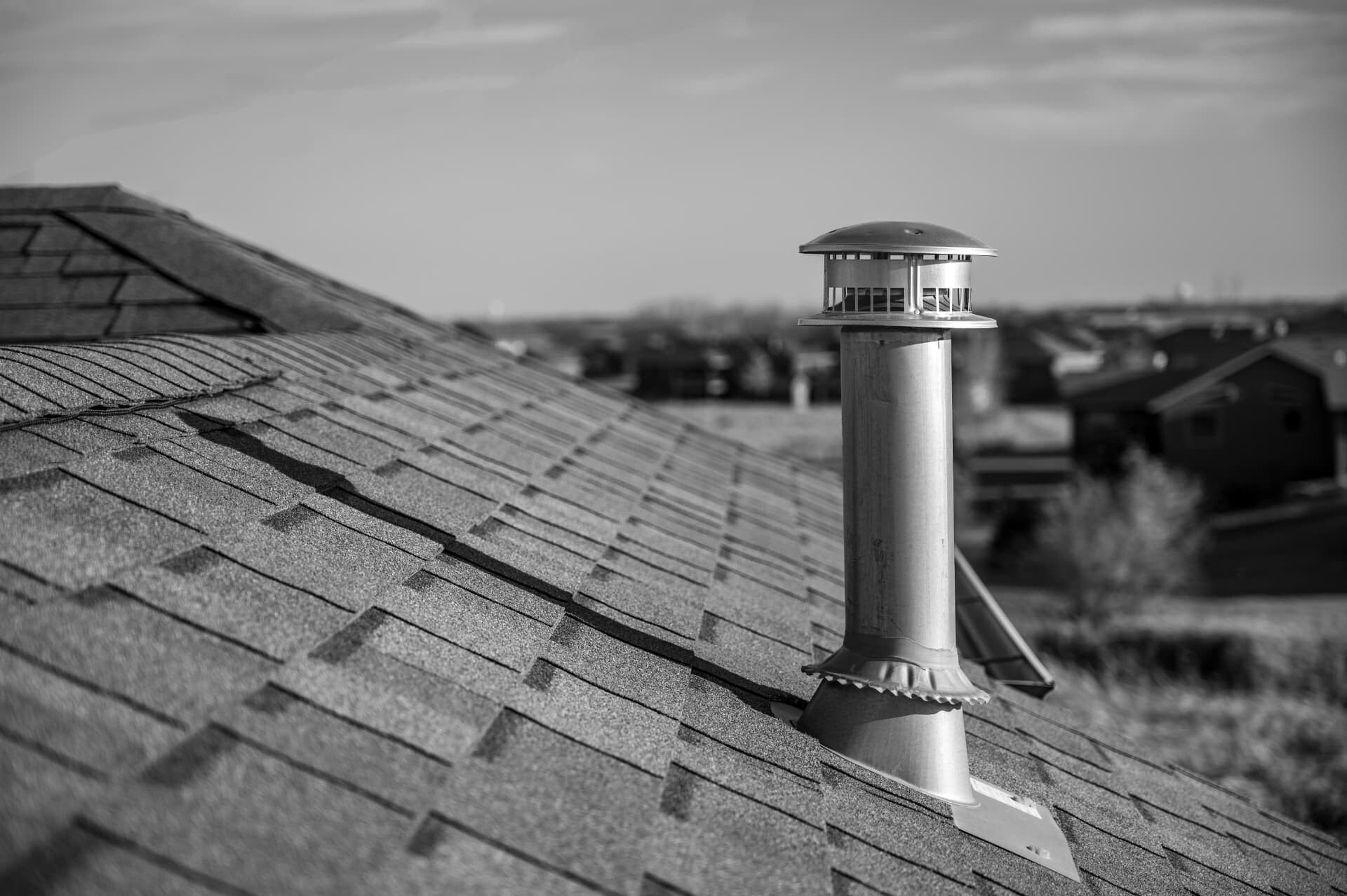 Architectural roof plan view showing shingles and a vent stack against a clear sky