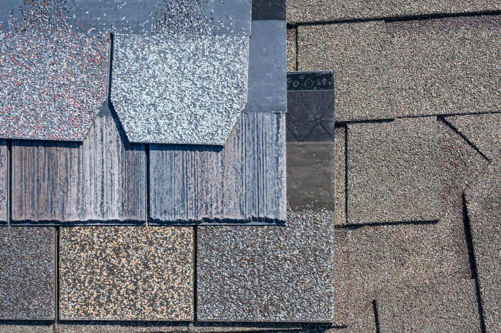 Asphalt shingle samples arranged on a roof to compare colors and textures